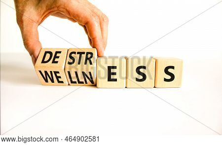 Destress For Wellness Symbol. Concept Words Destress And Wellness On Wooden Cubes. Businessman Hand.