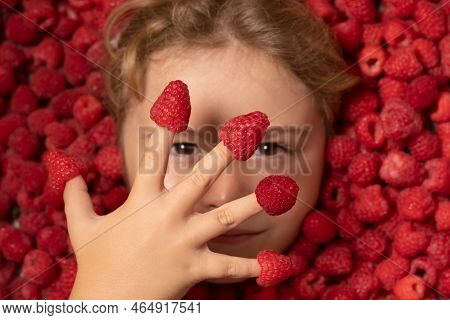 Fresh Raw Raspberry Near Kids Face. Raspberri Macro. Top View Of Collection Raspberries. Raspberries