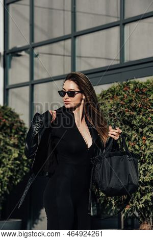 Fashionable Young Woman With Long Hair Wearing Solid Long Sleeve Bodycon One Piece Jumpsuits Posing 