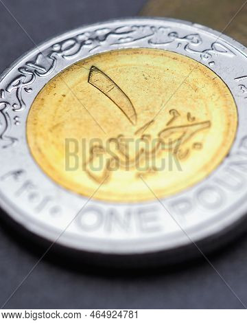 Translation: Arab Republic Of Egypt 1 Pound. Egyptian Coins Lie On Dark Gray Surface. Coin Of One Po