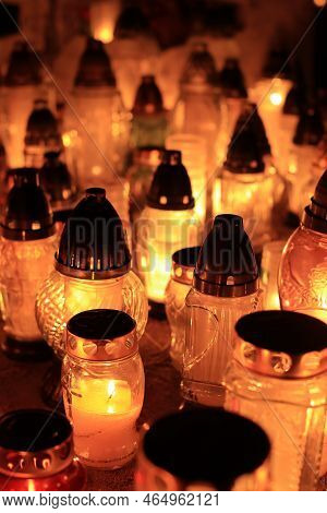 Yellow, Orange And Red Grave Candles Placed In The Cemetery, A Symbol Of Memory