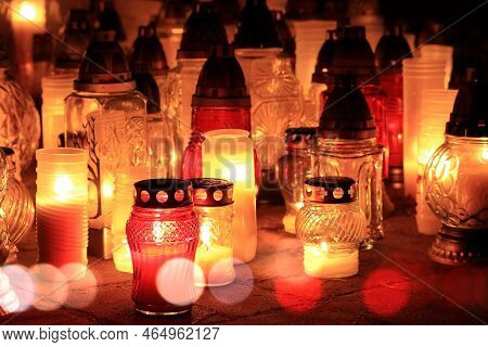 Yellow, Orange And Red Grave Candles Placed In The Cemetery, A Symbol Of Memory