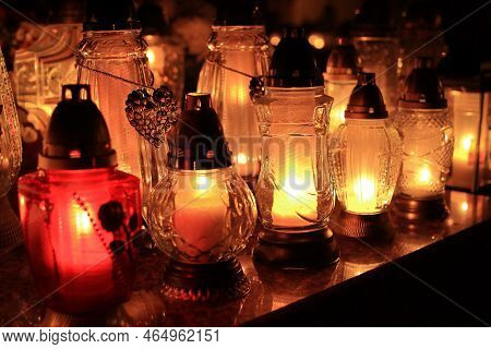 Yellow, Orange And Red Grave Candles Placed In The Cemetery, A Symbol Of Memory