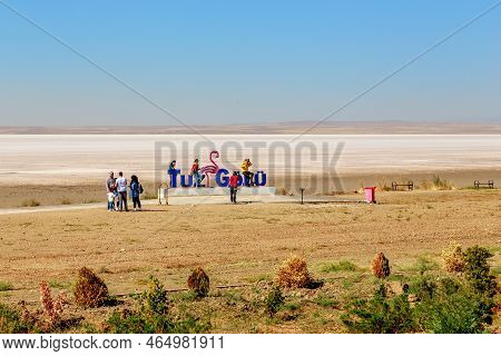 Turkey - October 3, 2020: This Is A Group Of Unidentified Tourists At A Sign On The Shore Of A Tus G