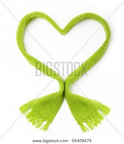 Green wool knitted scarf heart shape on white background.