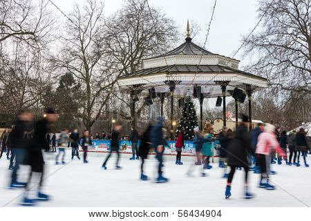 LONDON, UK - DECEMBER 13, 2012: People ice skate at the Winter Wonderland ice rink in Hyde Park.