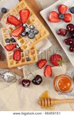 Sweet waffles with honey and berries