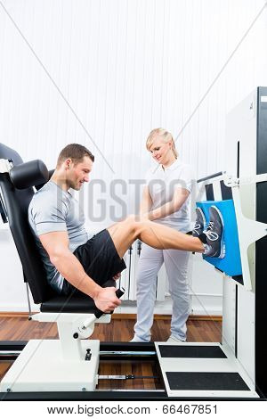 Patient at the physiotherapy doing physical exercises using leg press in sport remobilization