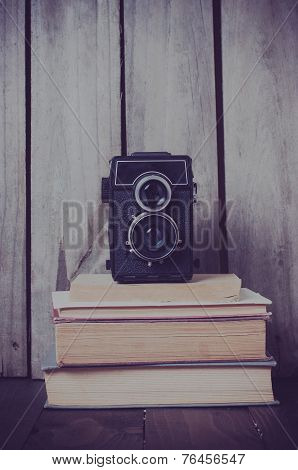 Camera And A Stack Of Books