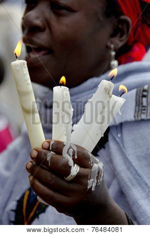 The Woman Prays With The Burning Candles In Hands.