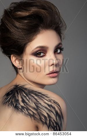 Portrait Of Young Sensual Brunette Woman With Black Wing