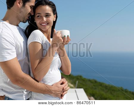 happy young romantic couple have fun relax smile at modern home outdoor terace balcony terace