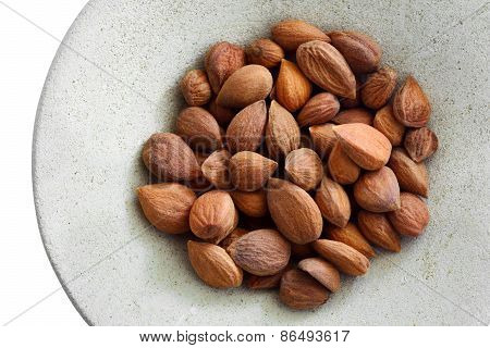 Apricot kernels on a round plate isolated