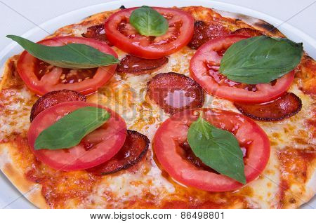 pizza with bacon, cheese and tomato