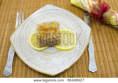 Juicy Baklava On A Plate Decorated With Lemon Slices