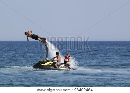 Unidentified Turkish Man Demonstrates Flyboard Acrobatics On The Beach Of Camyuva