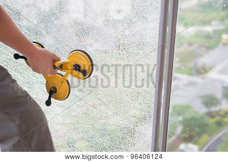 Taking Out On A Broken Window With Suction Plate
