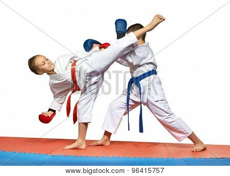 Two young athlete doing exercise paired karate