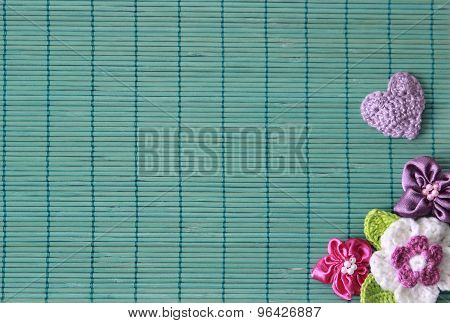 green background  with crochet flower and heart
