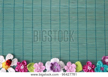 green background  with crochet flower and heart