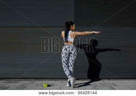 Portrait sporty woman with perfect figure and buttocks shape exercise against wall with copy space
