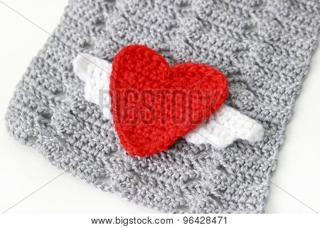 gray scarf with red crocheted heart