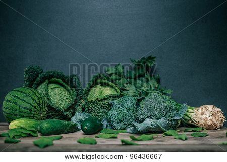 Various Green Vegetables On Wooden Table