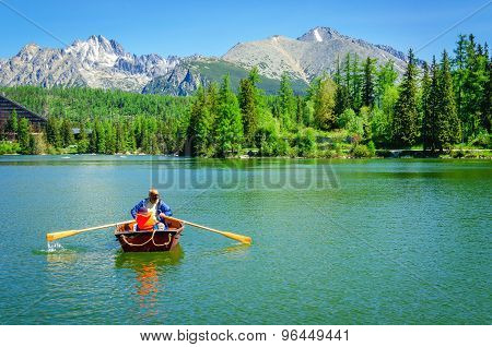 Father with child rowing in paddle boat