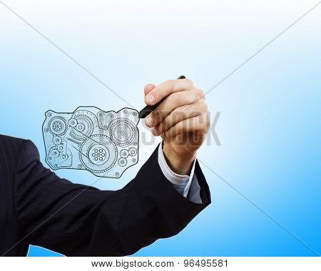 Close up of hand darwing gear mechanism with marker