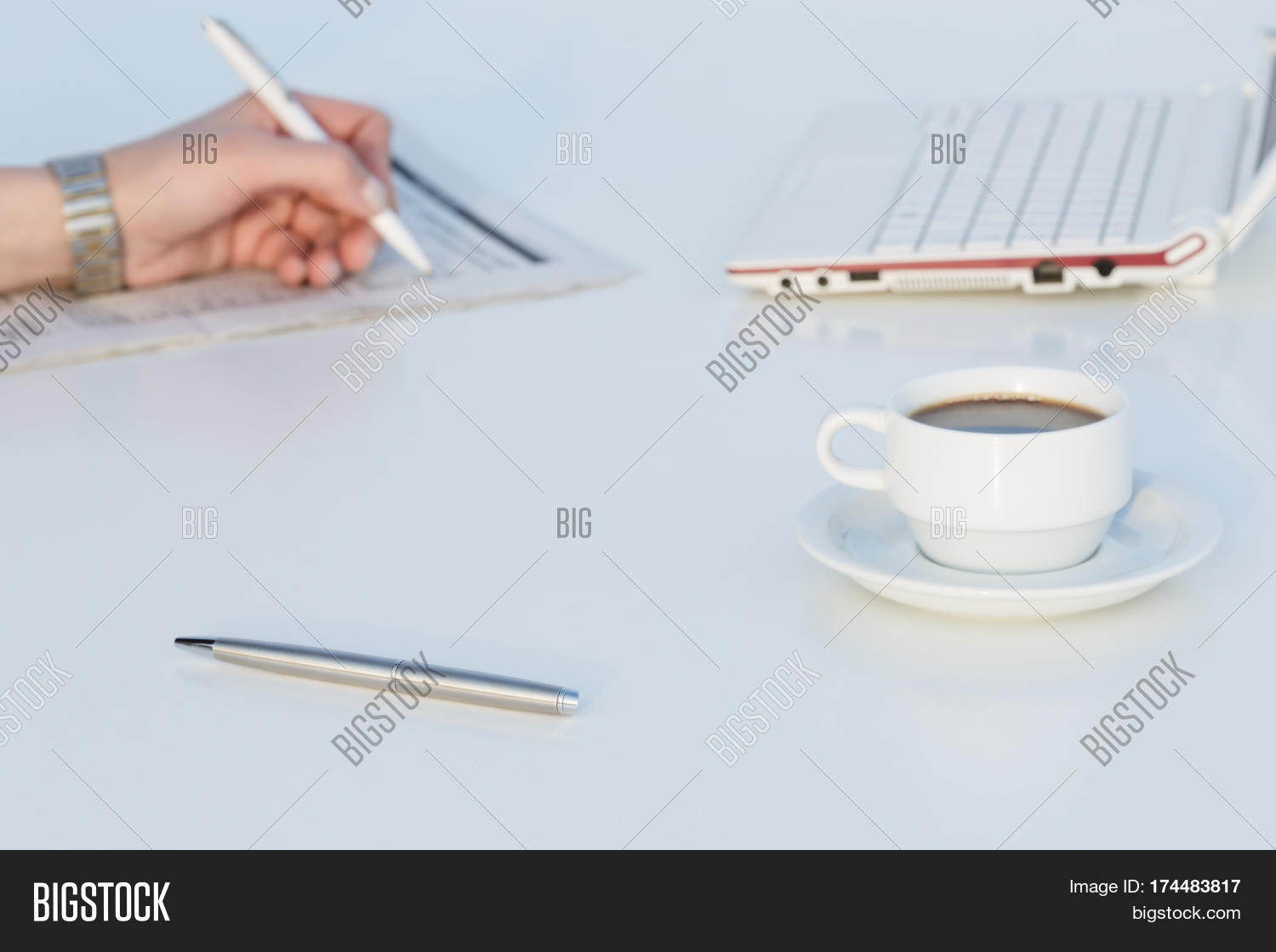 Angle View Of Work Place With Laptop Color Pencils Coffee Mug And Business Newspaper Person Hand Angle View Of Work Place With Laptop Color Pencils Coffee Mug And Business Newspaper Person Hand