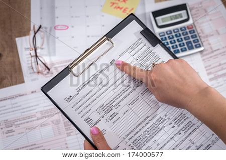 Business lady filling tax form. 2017. Financial concept.