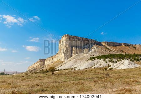 View of White rock or Aq Qaya on a Sunny summer day. Crimea. White limestone with a vertical cliff