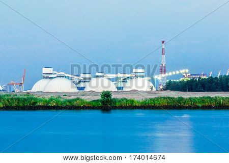 Riga fertilizer terminal with saltpeter against river coast