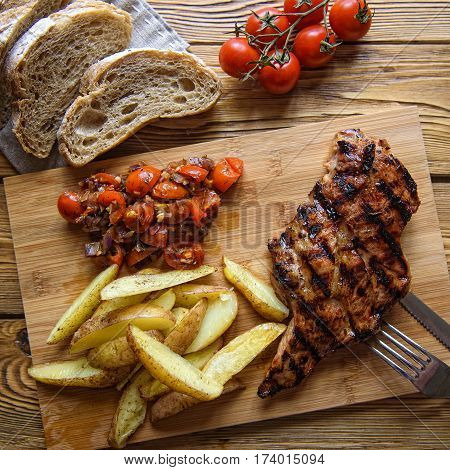 roast pork grilled with potatoes and tomatoes
