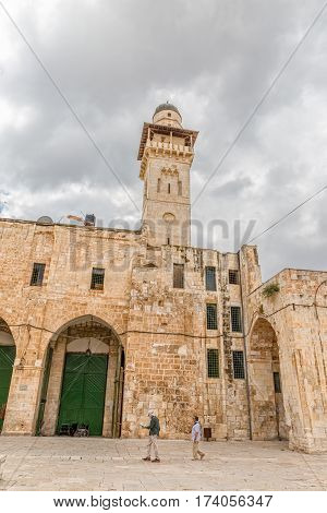 JERUSALEM, ISRAEL - MAY 23, 2016: Tourists visiting the Dome of the Rock and Bab el Ghawanimeh Mosque, an Islamic shrine located on the Temple Mount in the Old City.