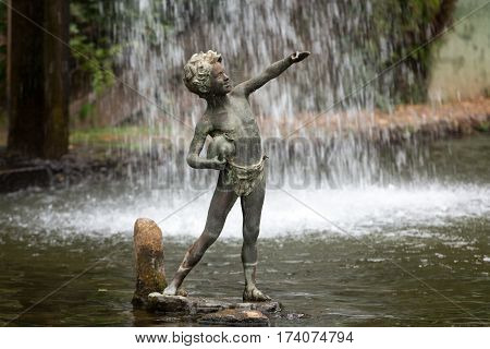 FUNCHAL MADEIRA PORTUGAL - SEPTEMBER 2 2016: Statue of boy in botanical garden Monte of Funchal Madeira. Portugal.