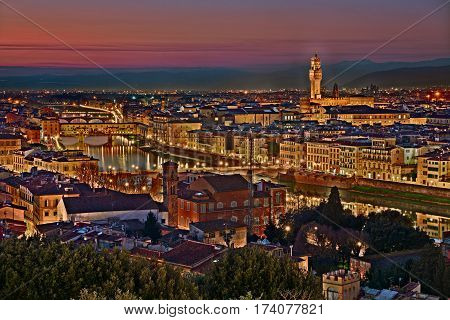 Florence, Tuscany, Italy: view at twilight of the city from Piazzale Michelangelo - landscape of the town and the Arno river with the old bridges