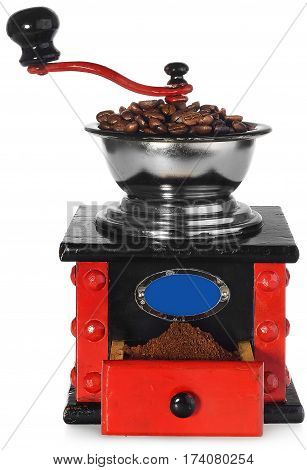 Old antique wooden coffee grinder with coffee beans and ground coffee. Coffee grinder hand-painted in black red and blue. The device isolated on a white background with light shadow and reflection.