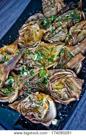 artichokes baked in oven seasoned only with olive oil parsley and lemon are a healthy and purifying food to stay fit during the summer