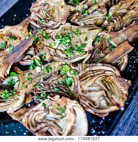 artichokes baked in oven seasoned only with extra virgin olive oil parsley and lemon are a healthy and purifying food to stay fit during the summer