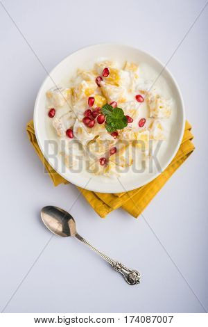ananas or anaanaas or pineapple raita, chopped pieces of pineapple mixed with sweet curd and garnished with pomegranate and mint, favourite side dish or starter food in India