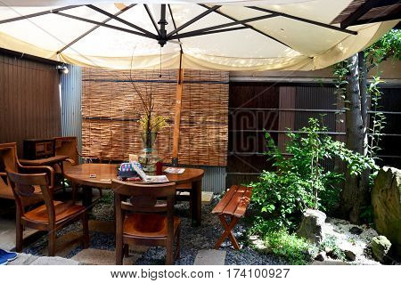 Decorative modern Wooden Furniture and umbella in the garden at outdoor of local house in Kyoto Japan