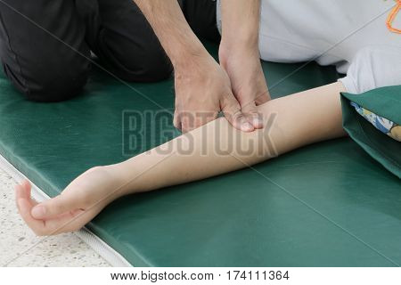 Deep tissue massage on arm closeup .