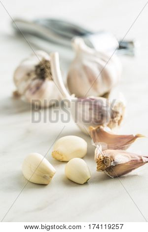 Peeled fresh garlic on kitchen table.