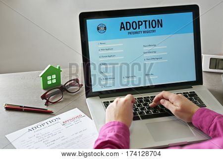 Woman filling adoption paternity registry in laptop