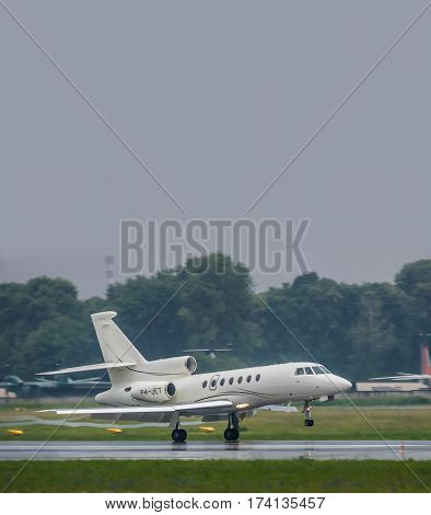 Kiev Ukraine - June 5 2012: Dassault Falcon 50EX business jet is landing in bad weather conditions under heavy rain