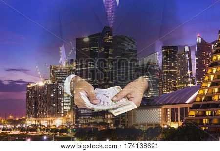 double exposure of businessman count the money night cityscape in money power concept - can use to display or montage on product