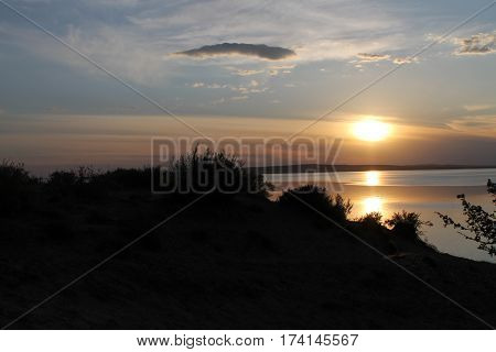 the setting sun reflected in the pond, lake, water, transparent