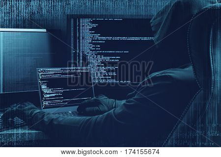 Internet concept. Hacker working on a code on dark digital background with digital interface around.