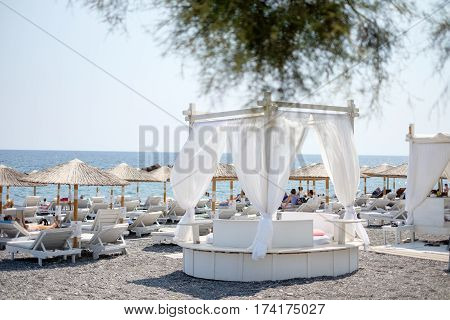 Umbrellas on Black beach of Kamari, Santorini, Greece